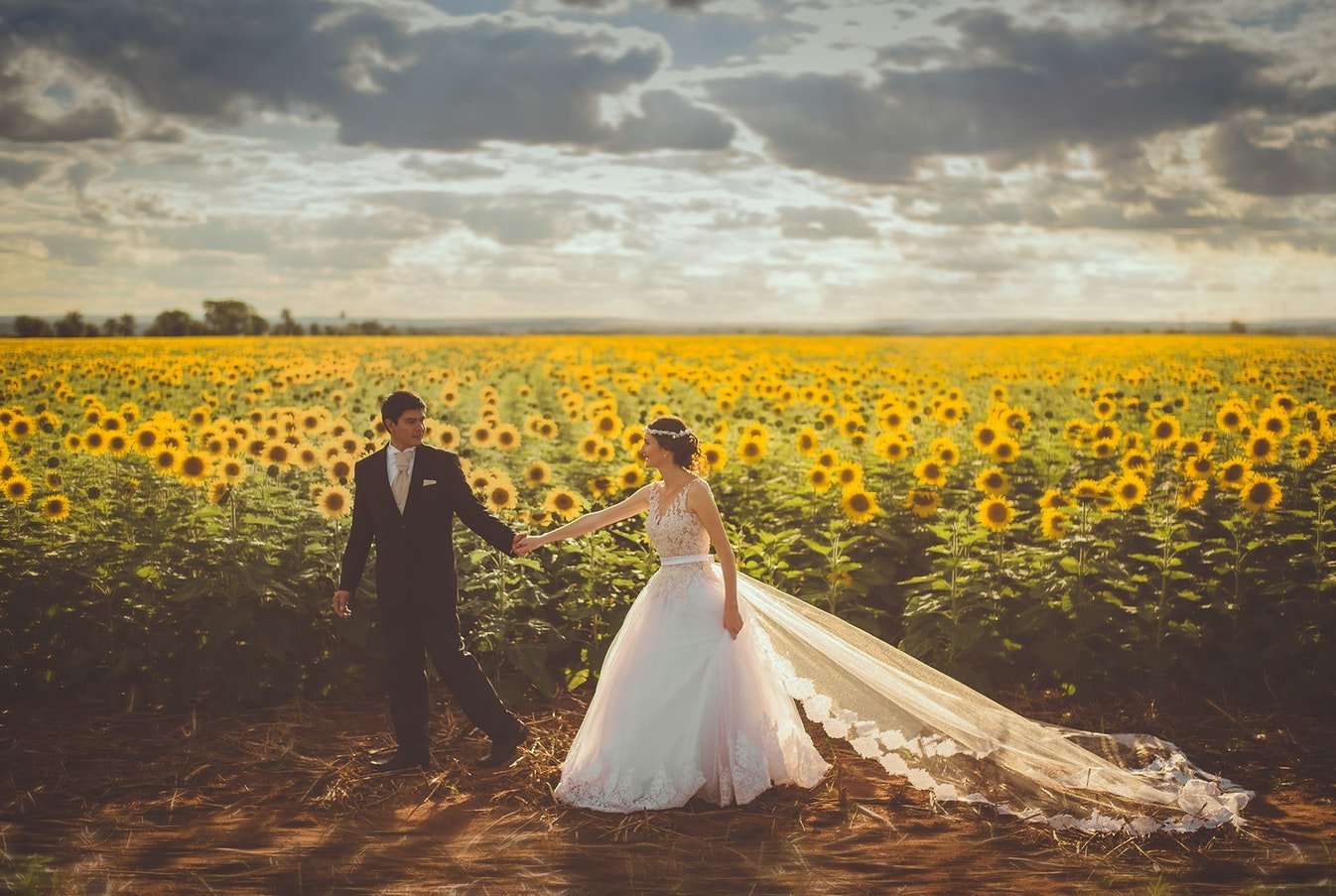 Bride in stunning gown at outdoor ceremony with golden hour lighting