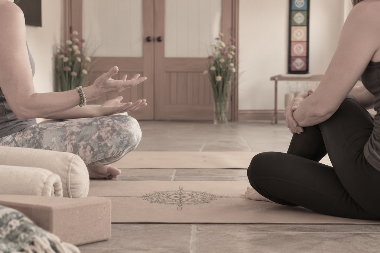 A gentle one-to-one yoga therapy session in a calm studio