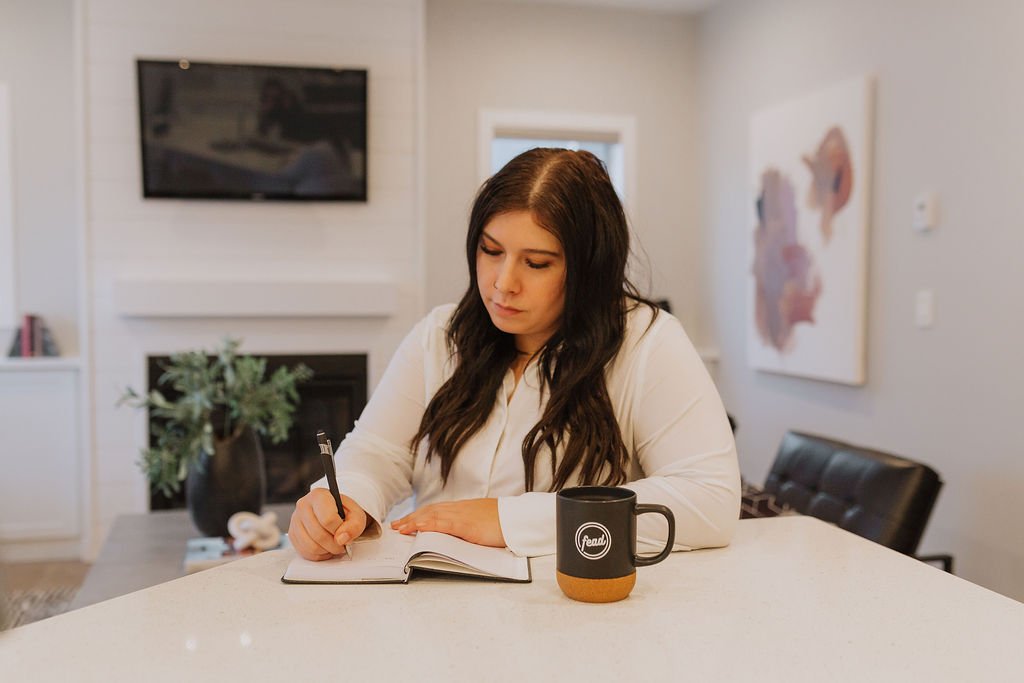 Lindsay Toth writing in her journal at home
