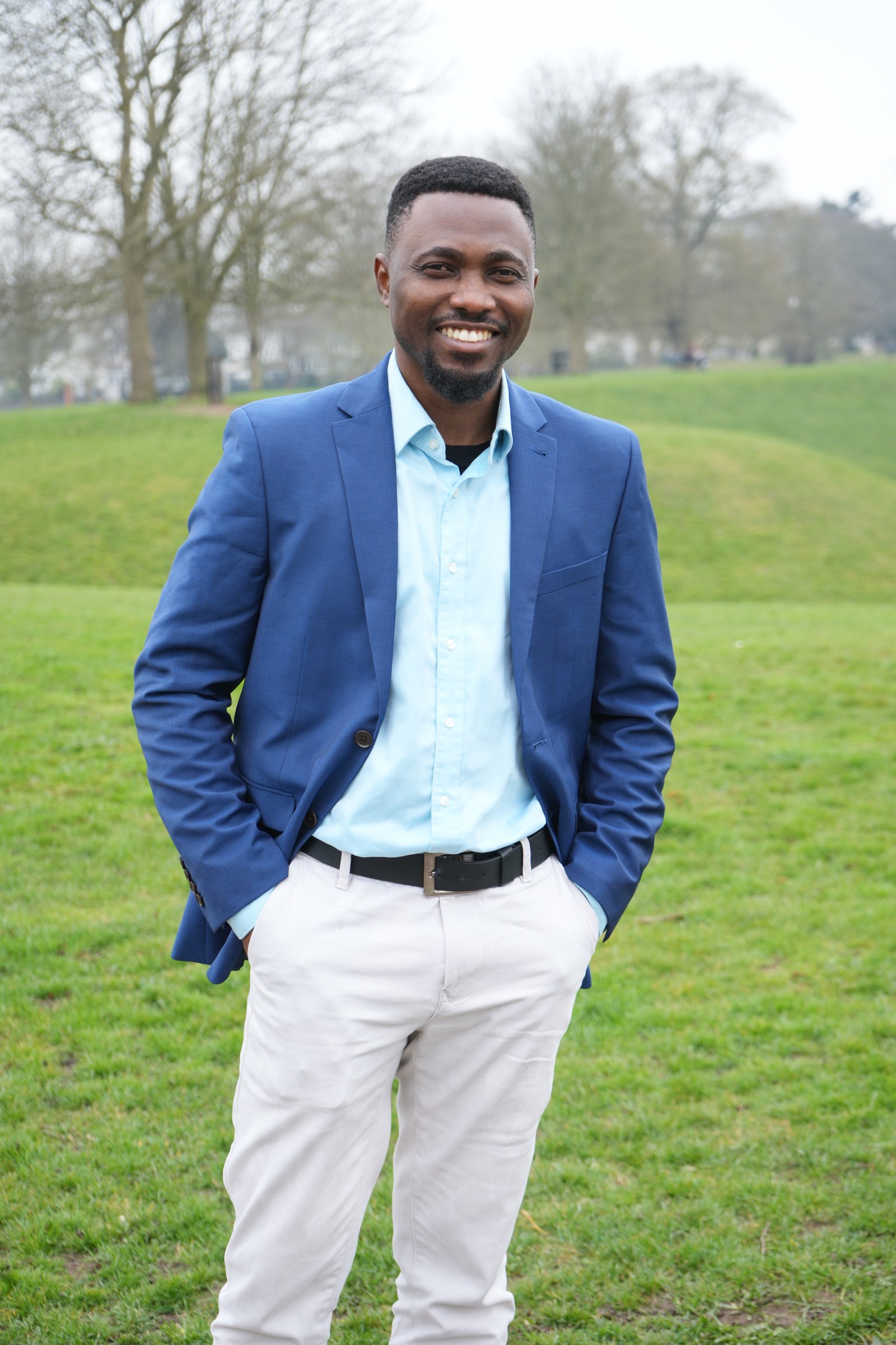 Joe Quarcoo smiling in an outdoor portrait.