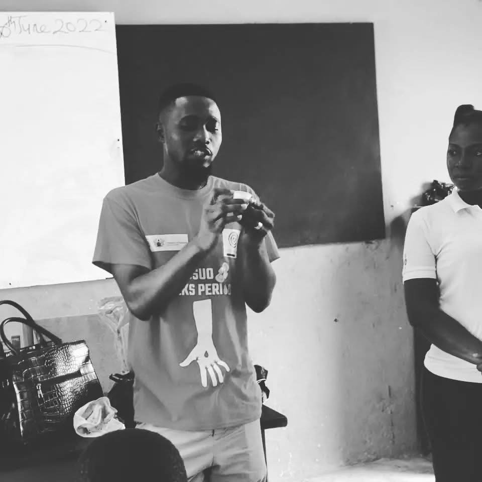 Joe Quarcoo demonstrating a menstrual cup during a Nkosuo Initiative Foundation education session.