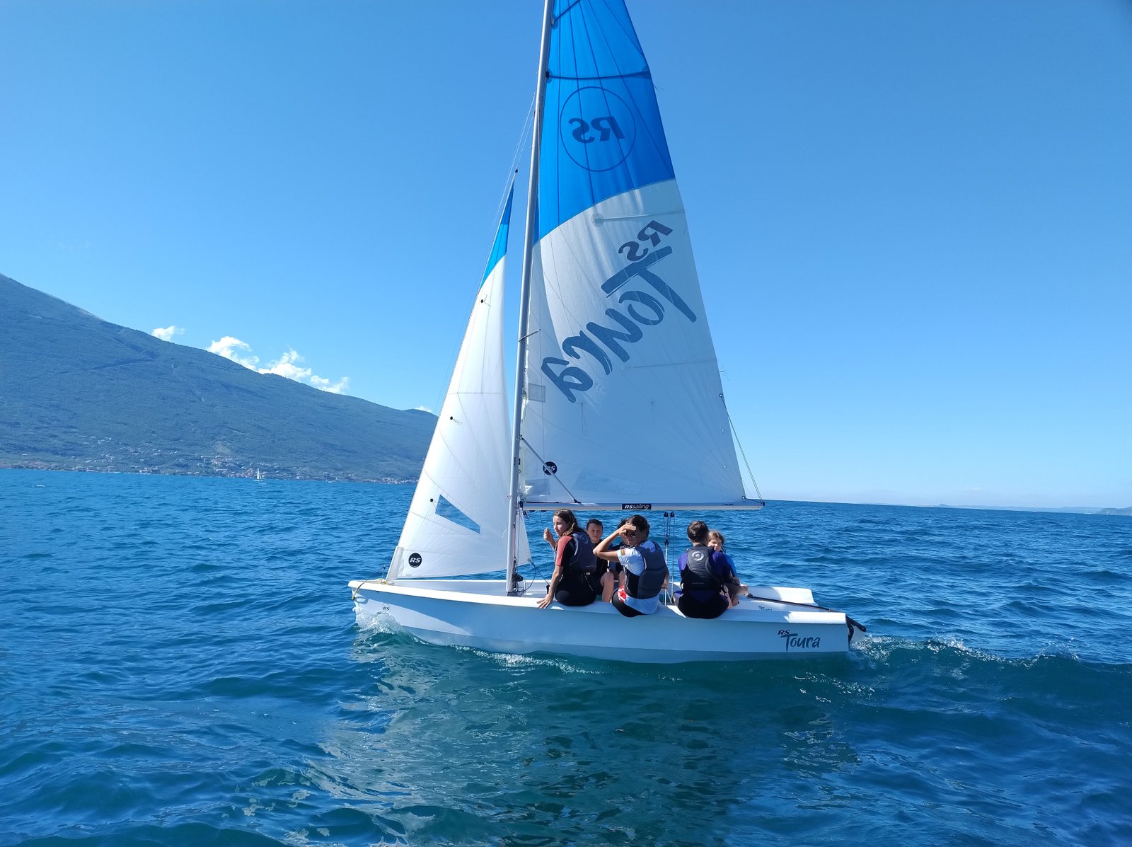 Sailing on Lake Garda with Dolomite mountains