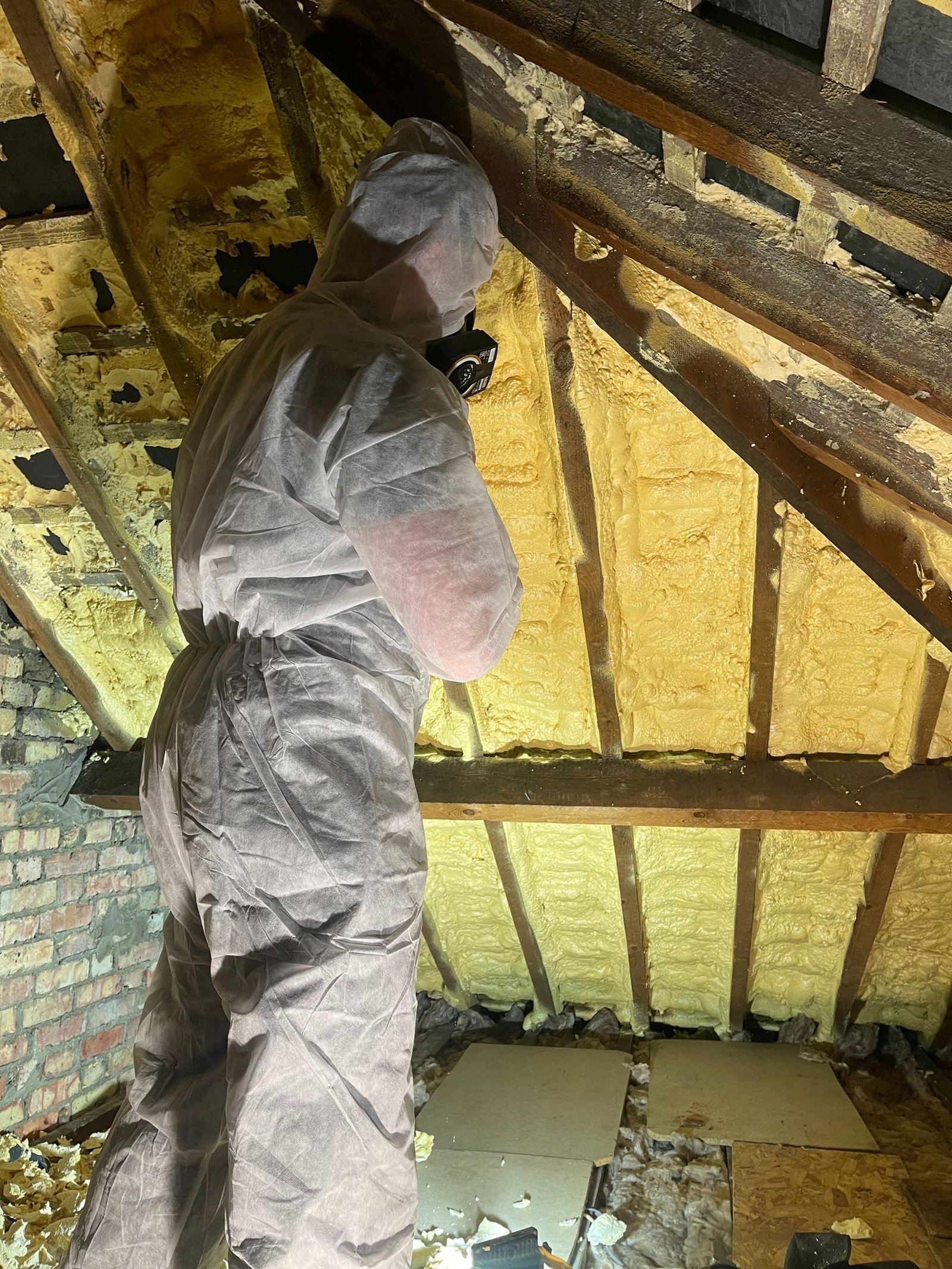Professional spray foam removal specialist at work