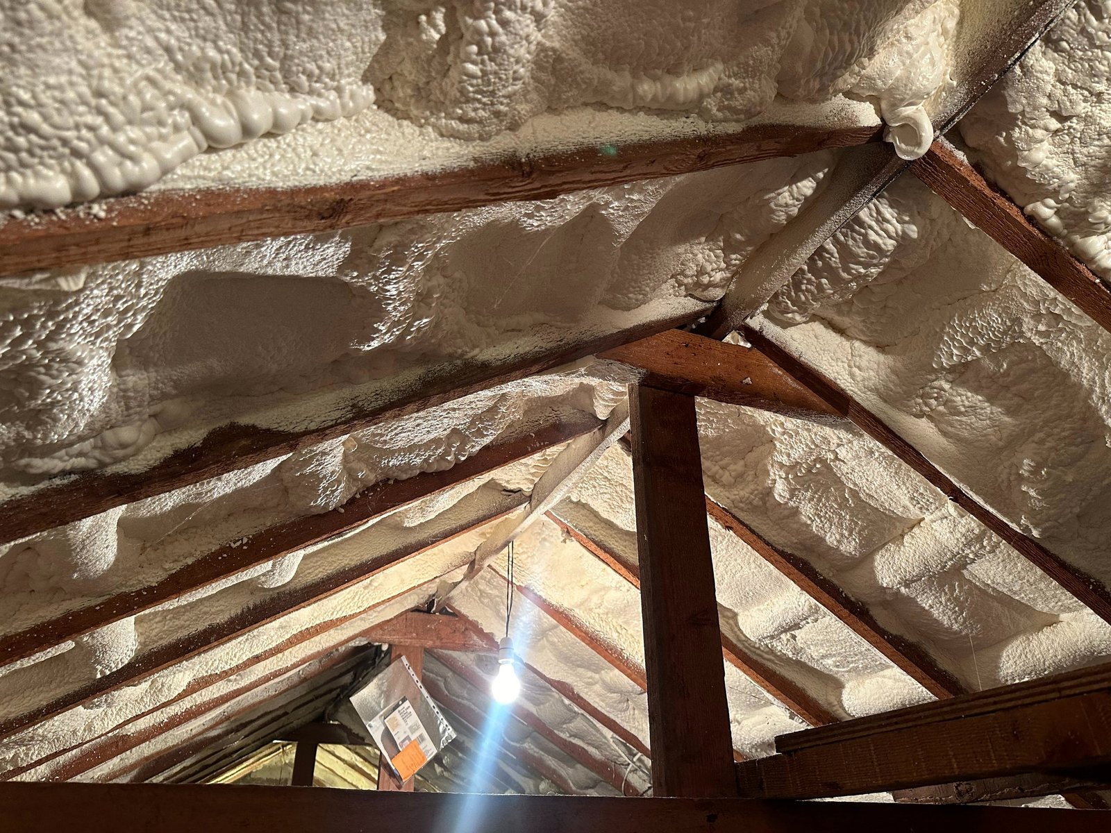 Spray foam insulation being assessed in a loft