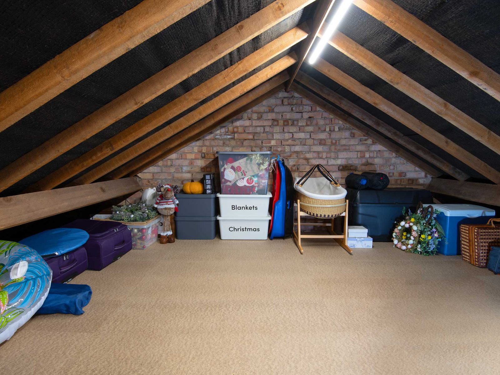 Organised loft storage on a boarded attic floor with a safe access walkway