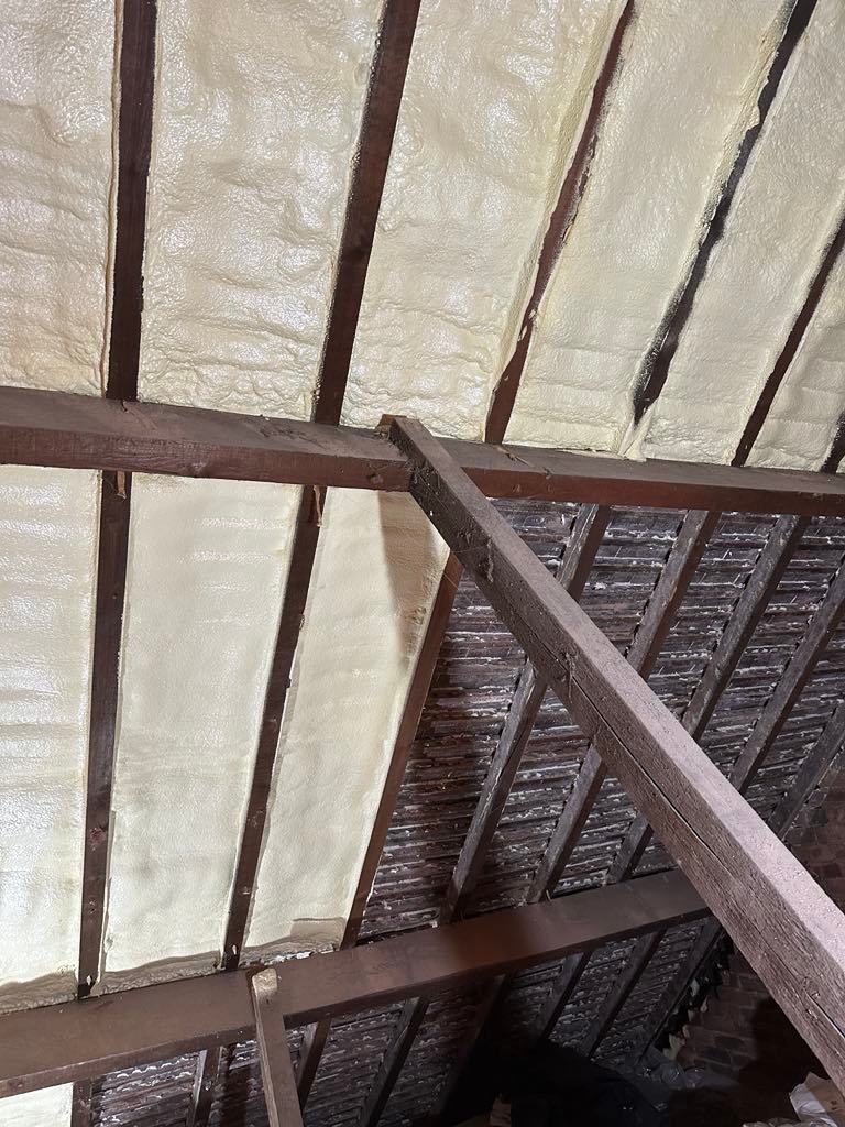 Spray foam being carefully removed from a loft roof