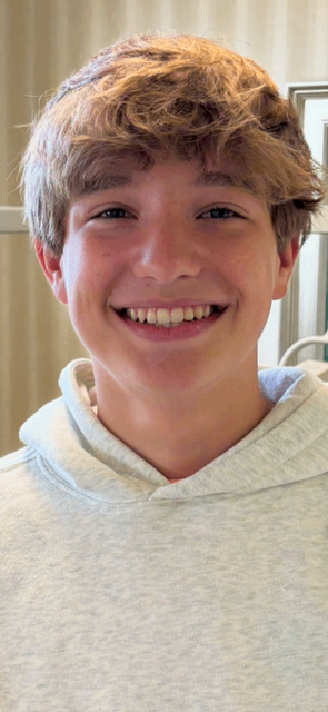 Young patient smiling in gray hoodie