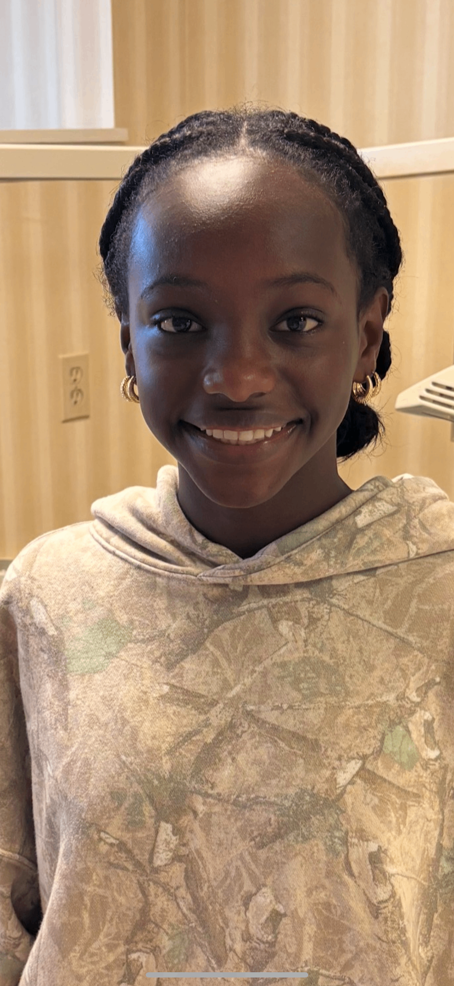 Young patient in camouflage hoodie smiling