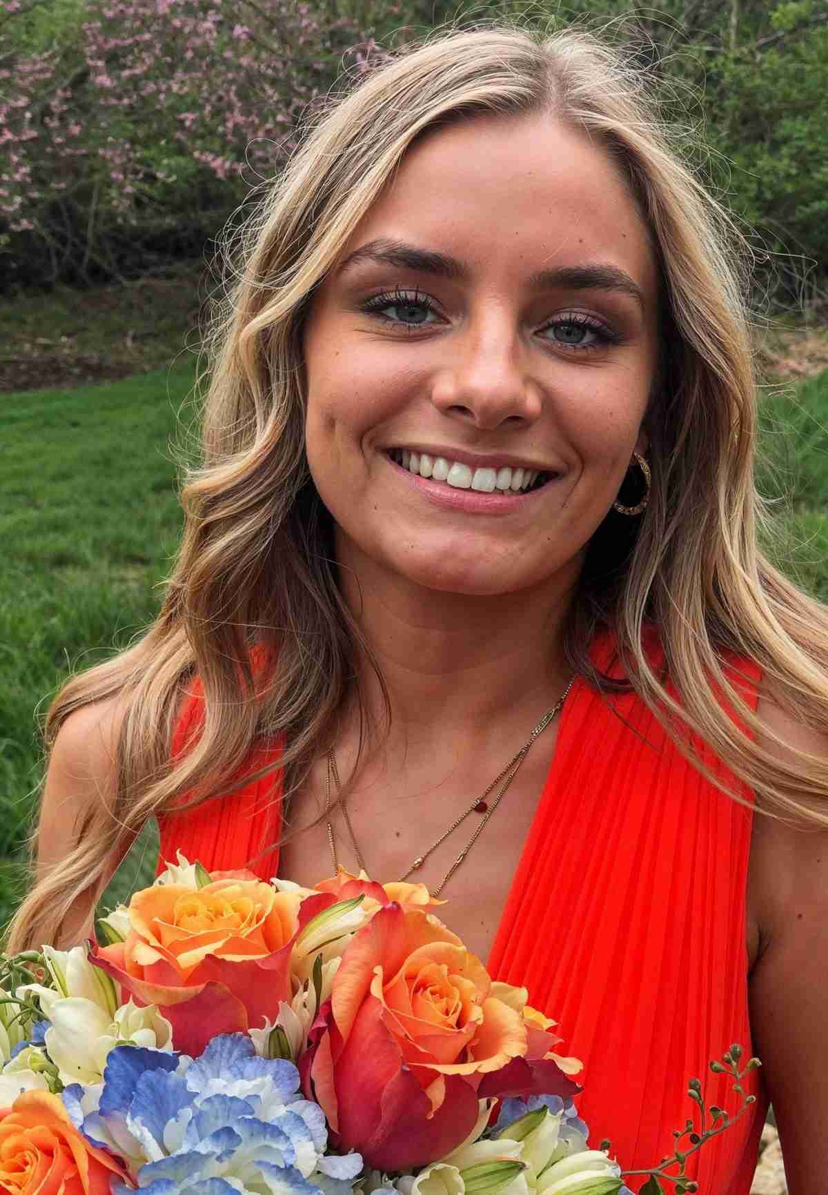 Portrait of woman holding orange flowers