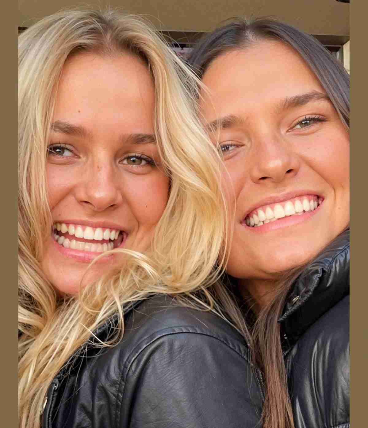 Two smiling friends posing close together