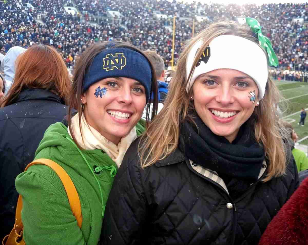 Two friends with face paint at a stadium