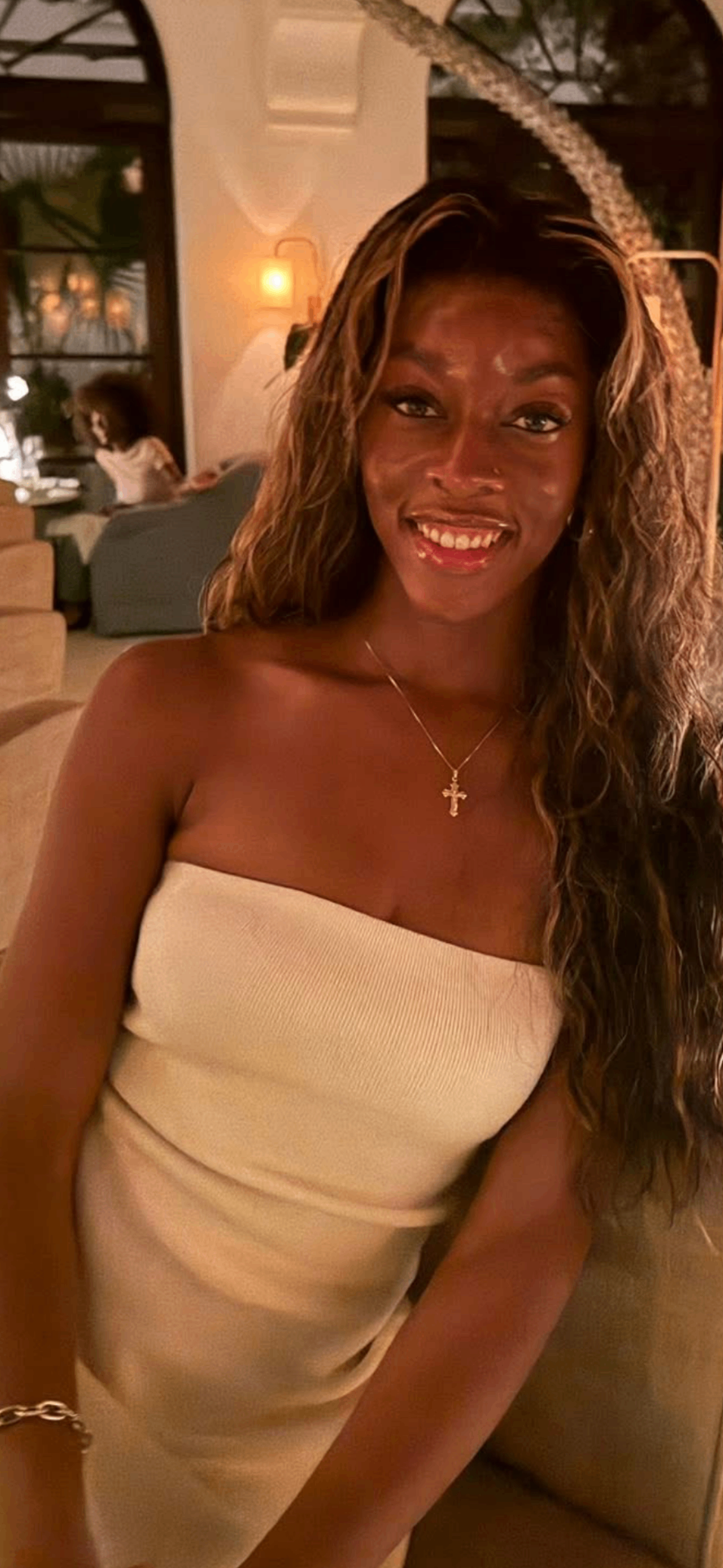 Patient in elegant white dress smiling