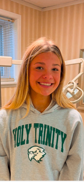 Patient smiling in Holy Trinity hoodie
