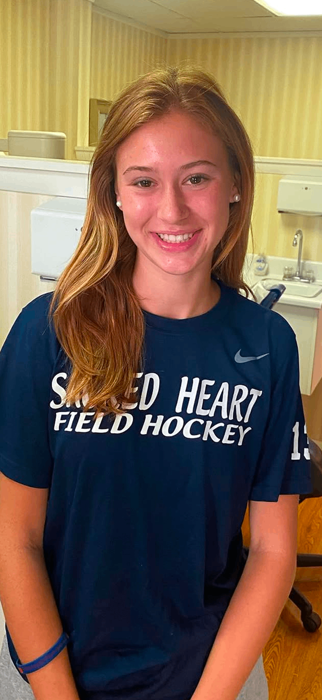 Happy patient in a blue Sacred Heart shirt