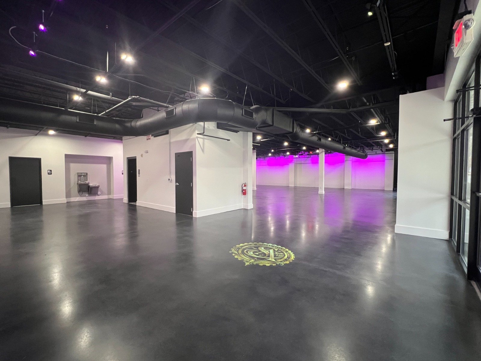 Inside The Social Atelier — polished floors, open hall, soft light