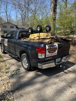 Truck with large tires loaded with junk and debris