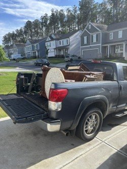 Residential driveway with a truck fully loaded with furniture and household items