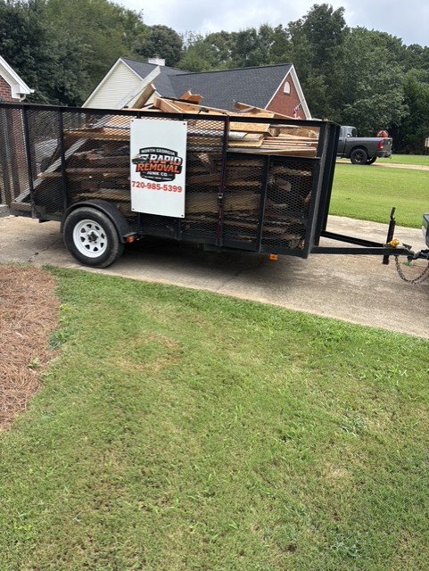 Rapid Removal trailer loaded with wood debris after job completion