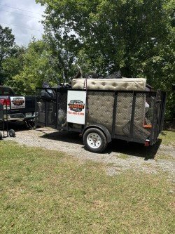 Utility trailer loaded with junk and debris