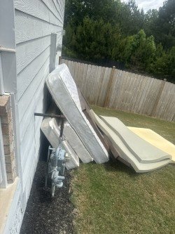 Mattress and furniture items loaded on truck bed