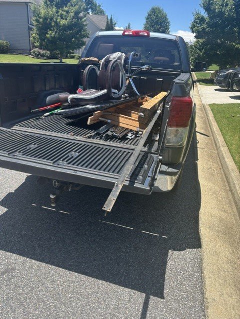 Truck bed loaded with furniture and materials