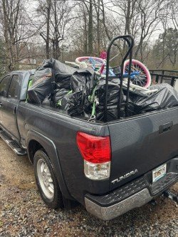 Truck loaded with a bike and various household junk items ready for disposal