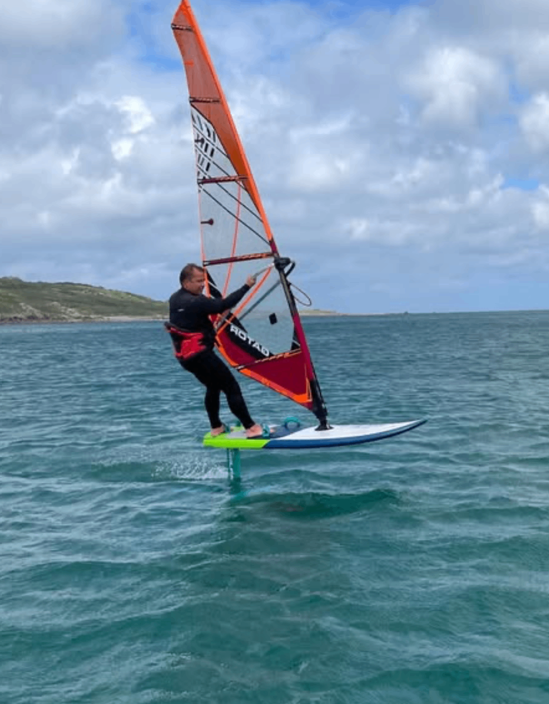 Instructor wingsurfing on a foil board