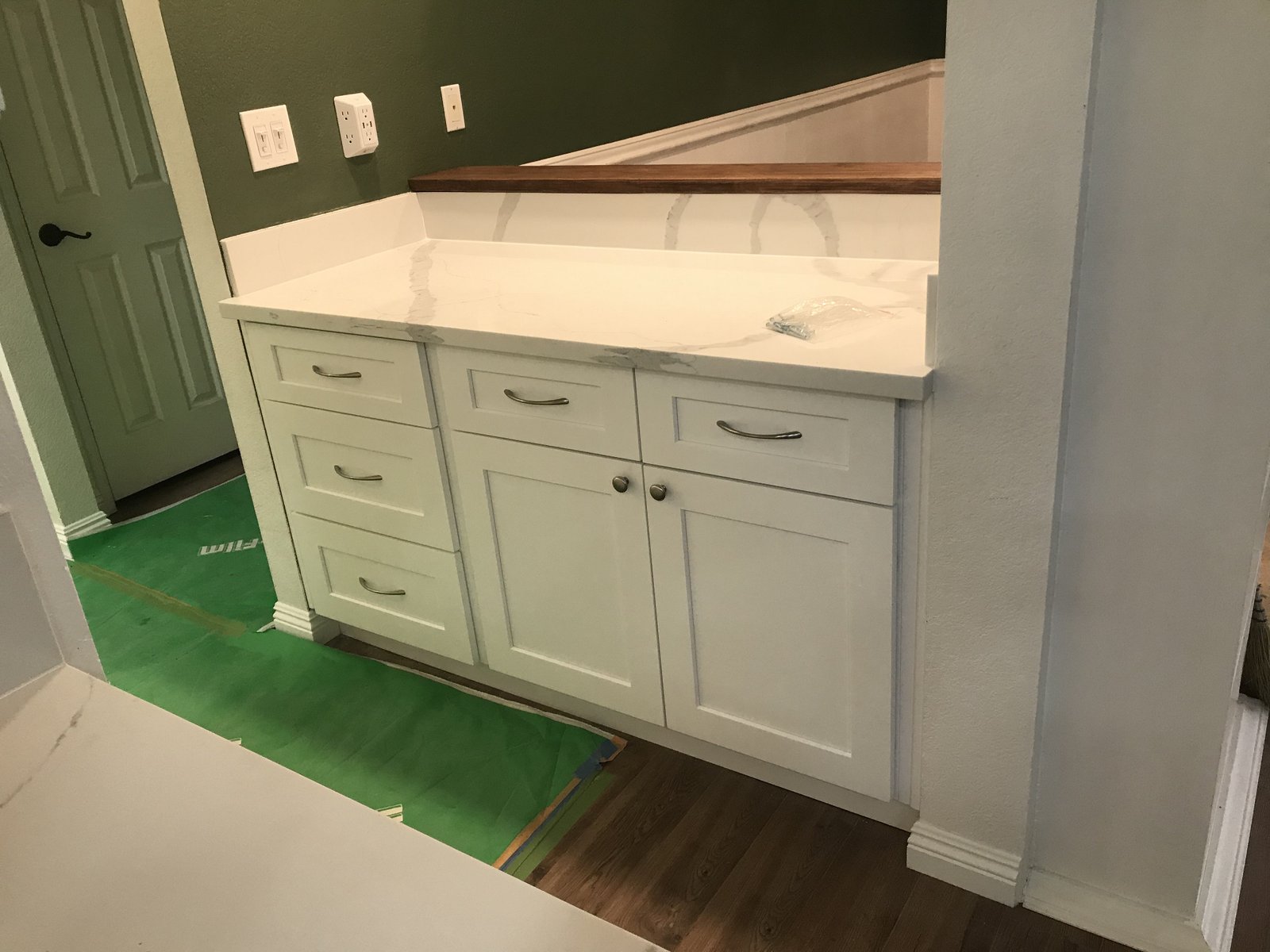 After: restored kitchen wet bar with white cabinetry
