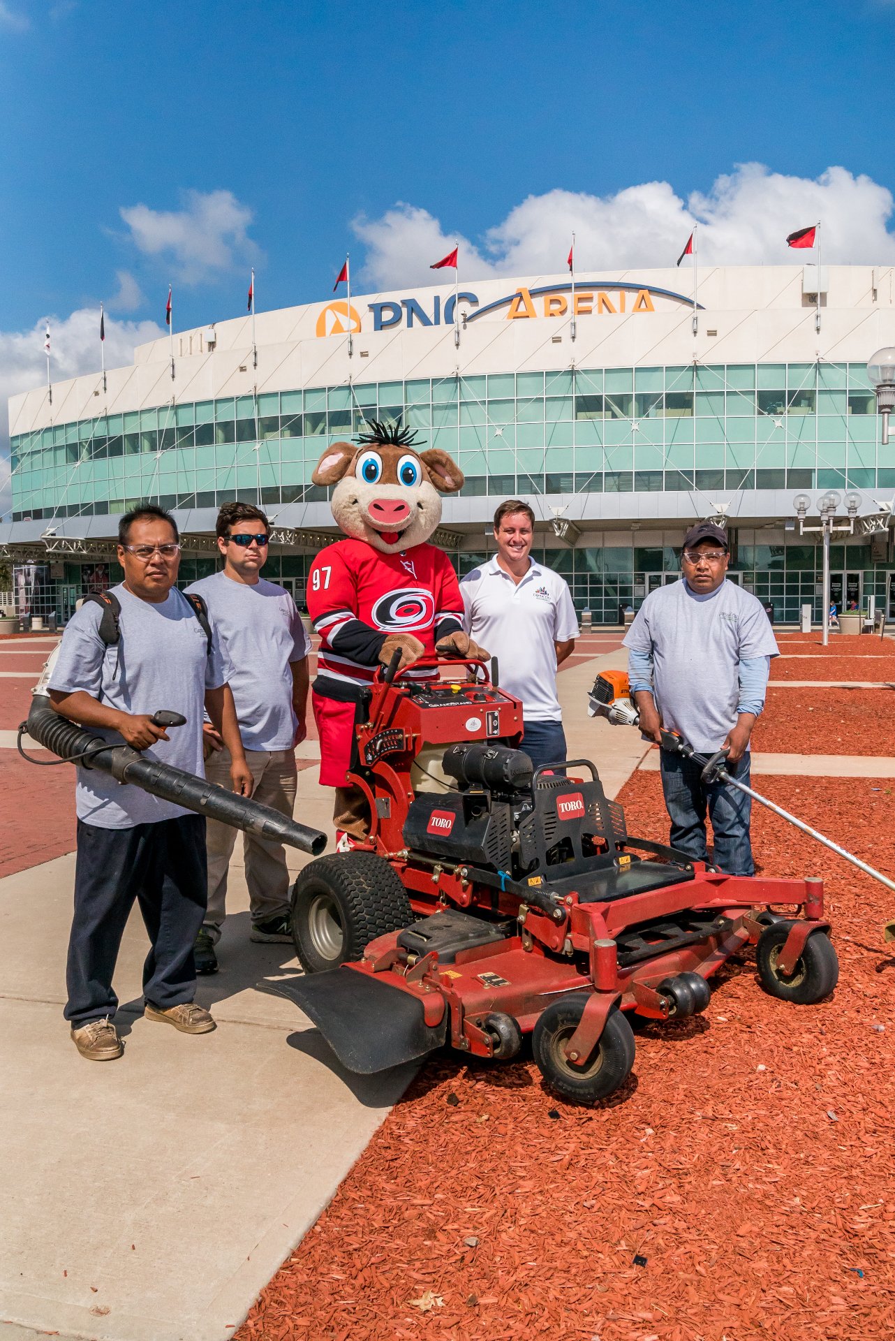 The Capital City Groundskeeping crew with equipment in front of their truck