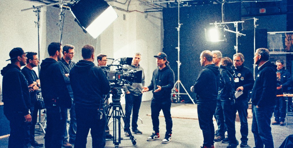 Zatka Media production crew gathered around a cinema camera on set