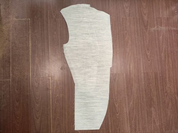 Pre-shaped horsehair chest piece canvas components stacked on a workbench