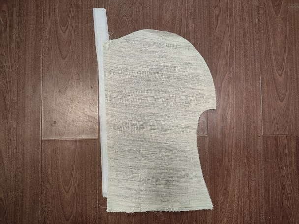Rolled sleeve head interlining strips coiled on a wooden table