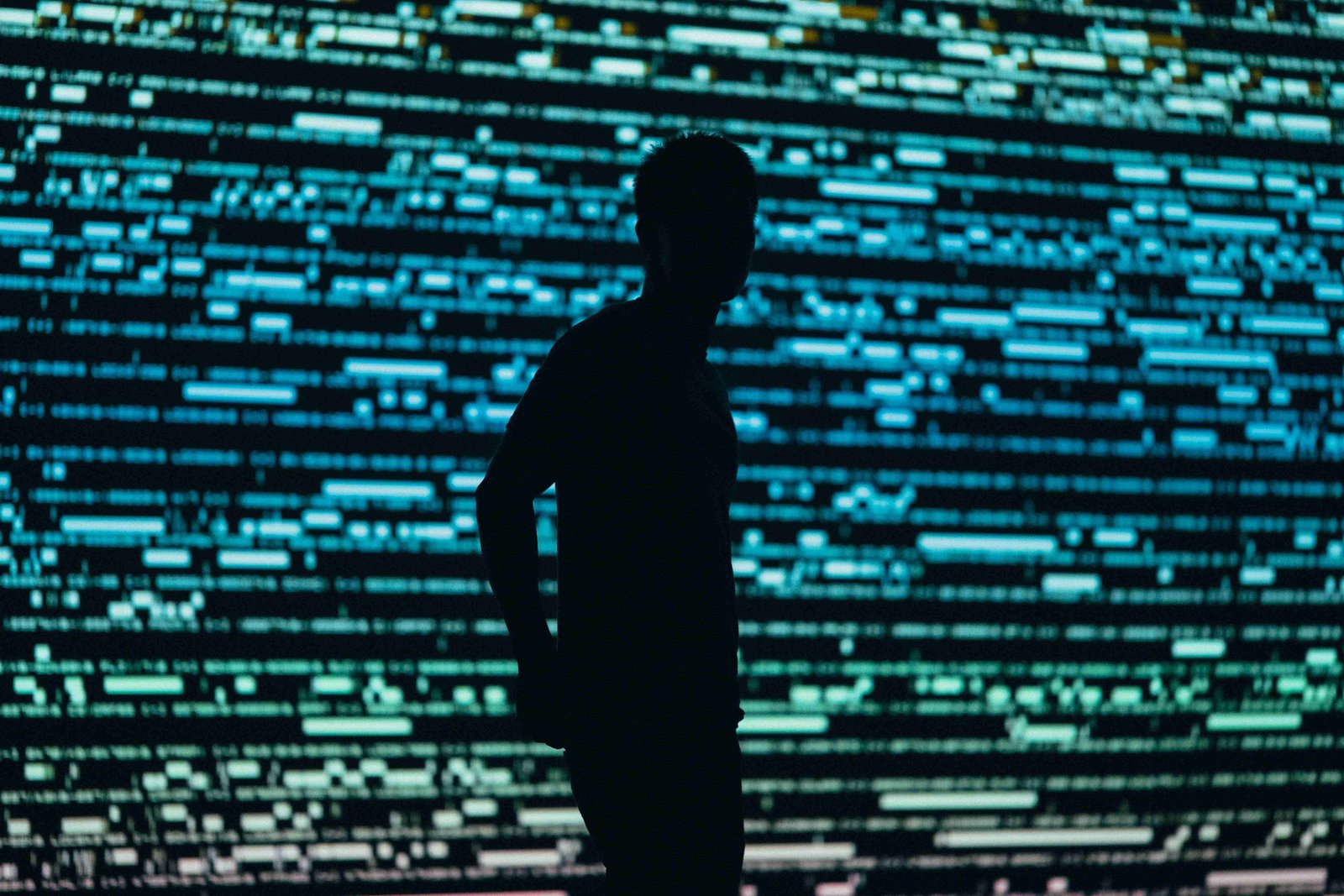 Silhouette of a person against a background of digital code, representing privacy and data security.