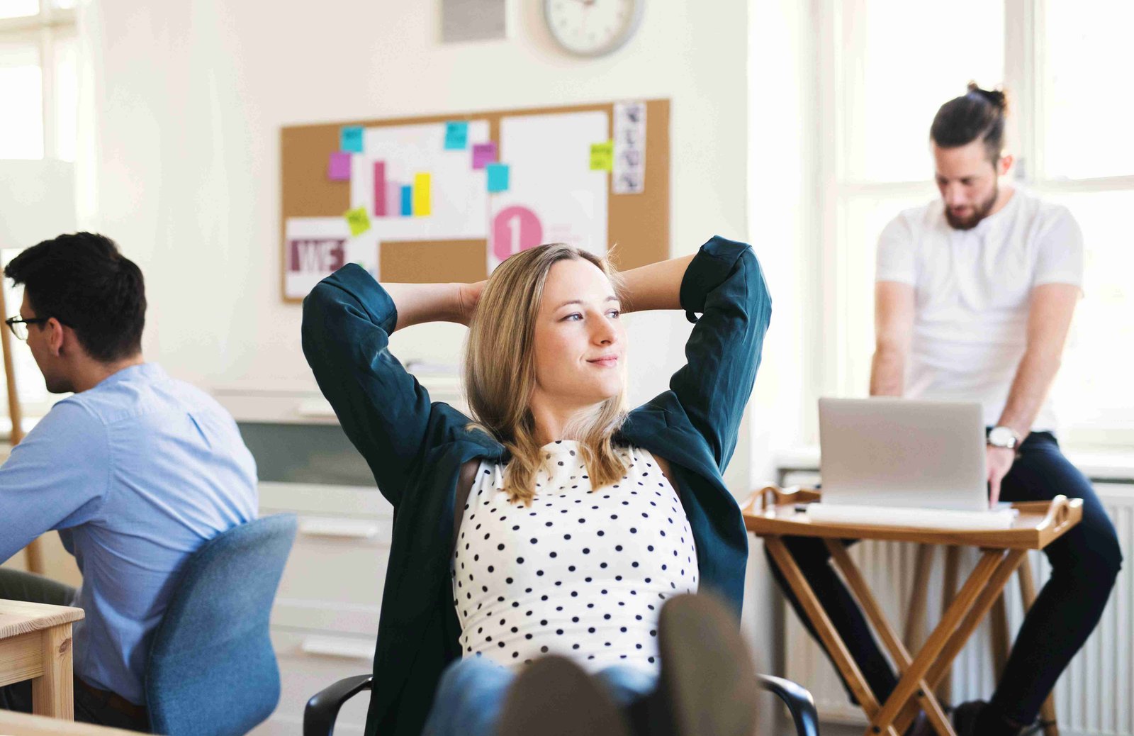 A relaxed team in a modern office, symbolizing a chaos-free work environment.