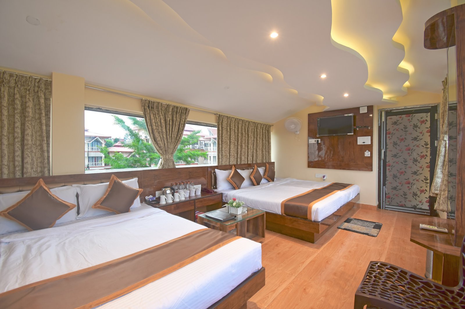 Guest Dorm bedroom with multiple beds, orange and white bedding