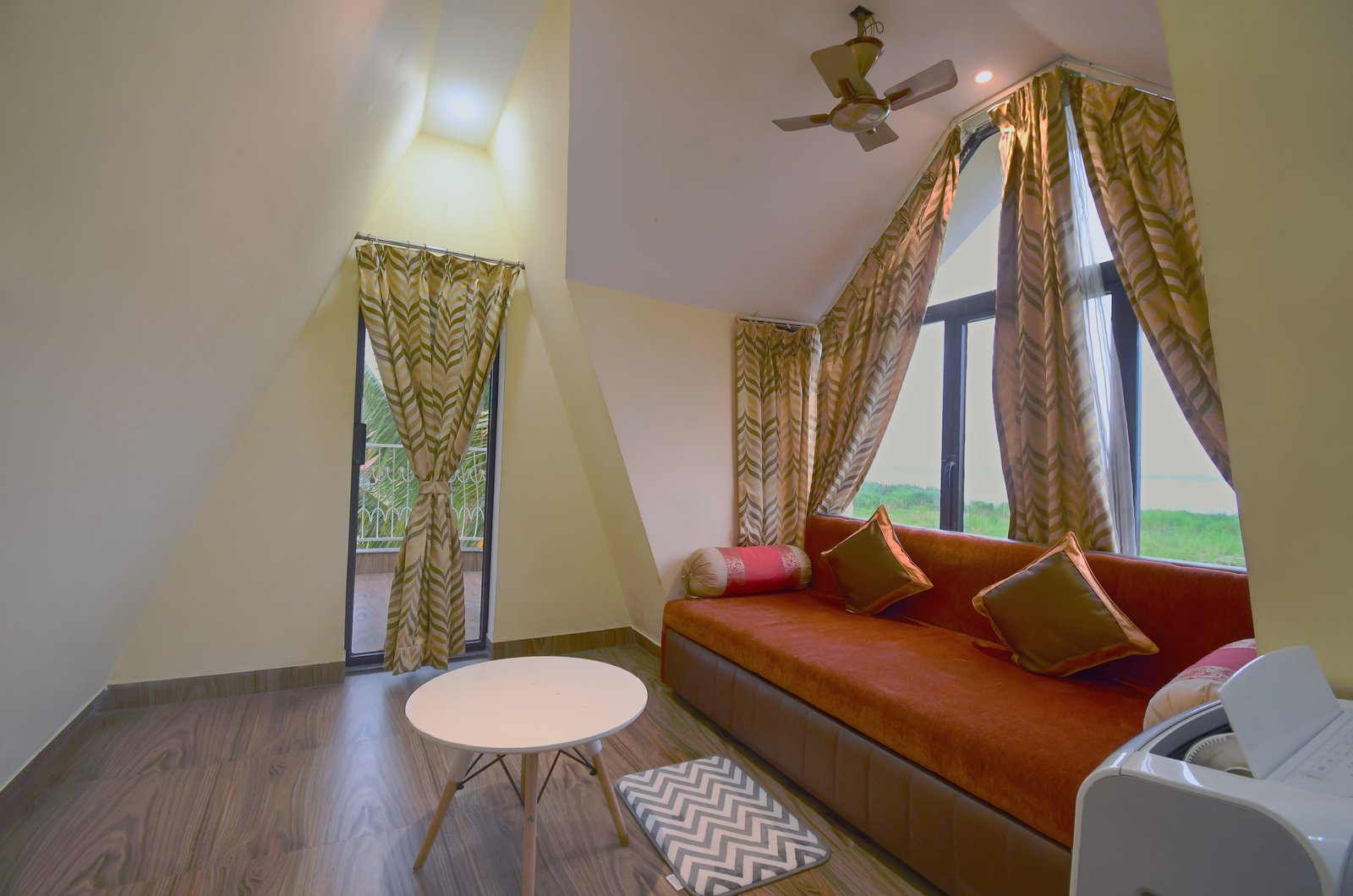 Cozy loft area featuring a comfortable red sofa cum bed