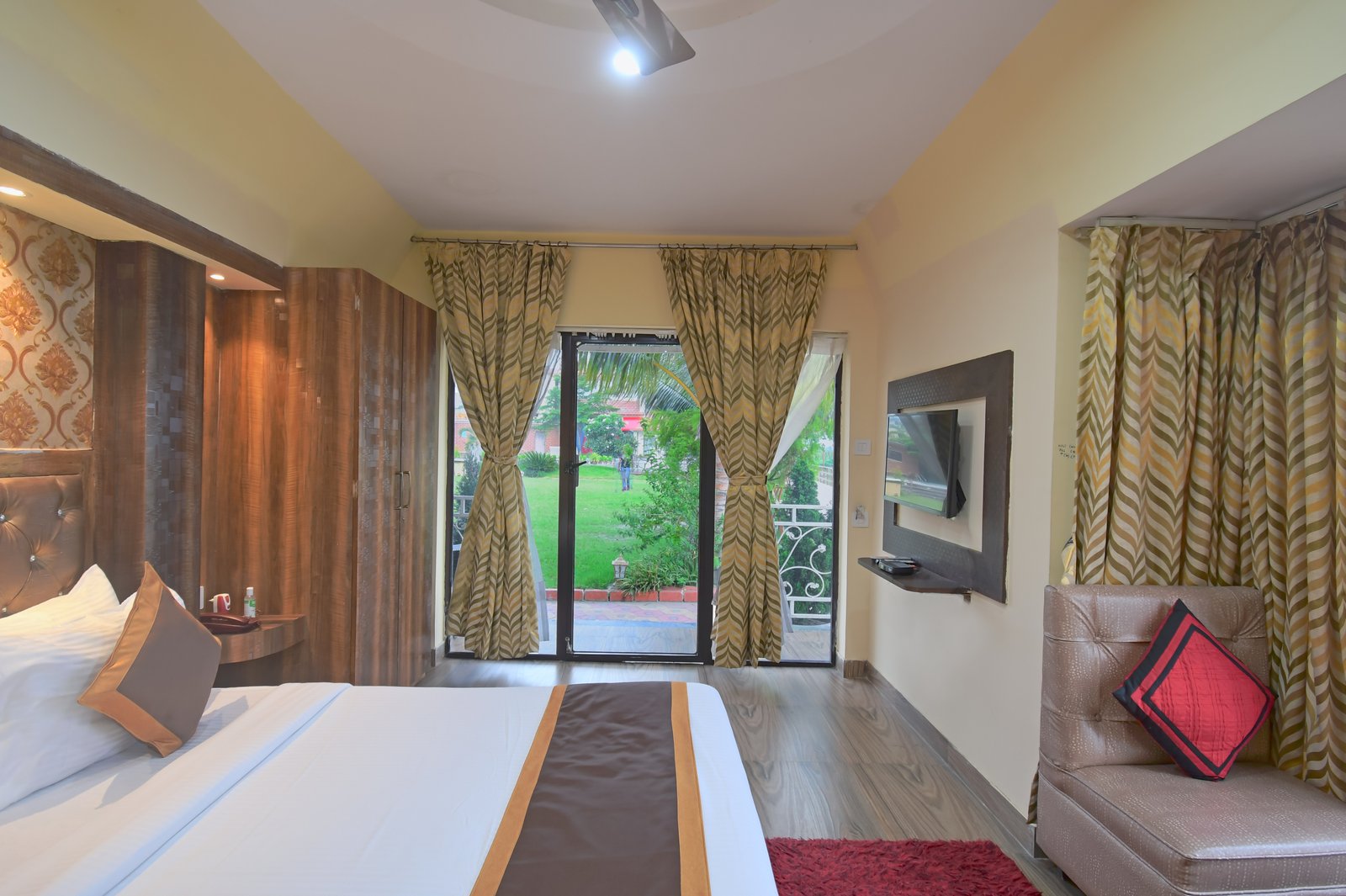 Primary bedroom with a plush king size bed and vibrant orange and white bedding