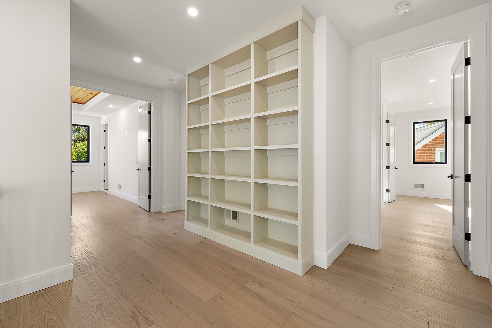 Custom built in hallway shelving and trim carpentry by ExquisiteHaus