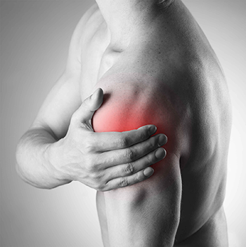 Person from behind holding their shoulder with red pain highlighting