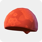An orange knit cap printed with a large red rose and daisy motifs.