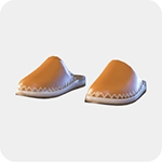 A pair of tan leather mules with a pointed toe and white whipstitched trim.