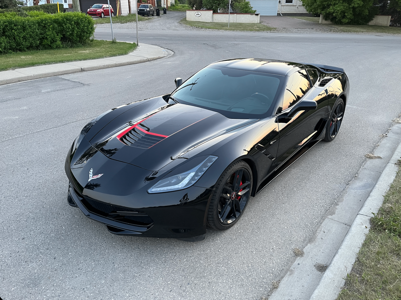 Black Chevrolet Corvette parked on a residential street
