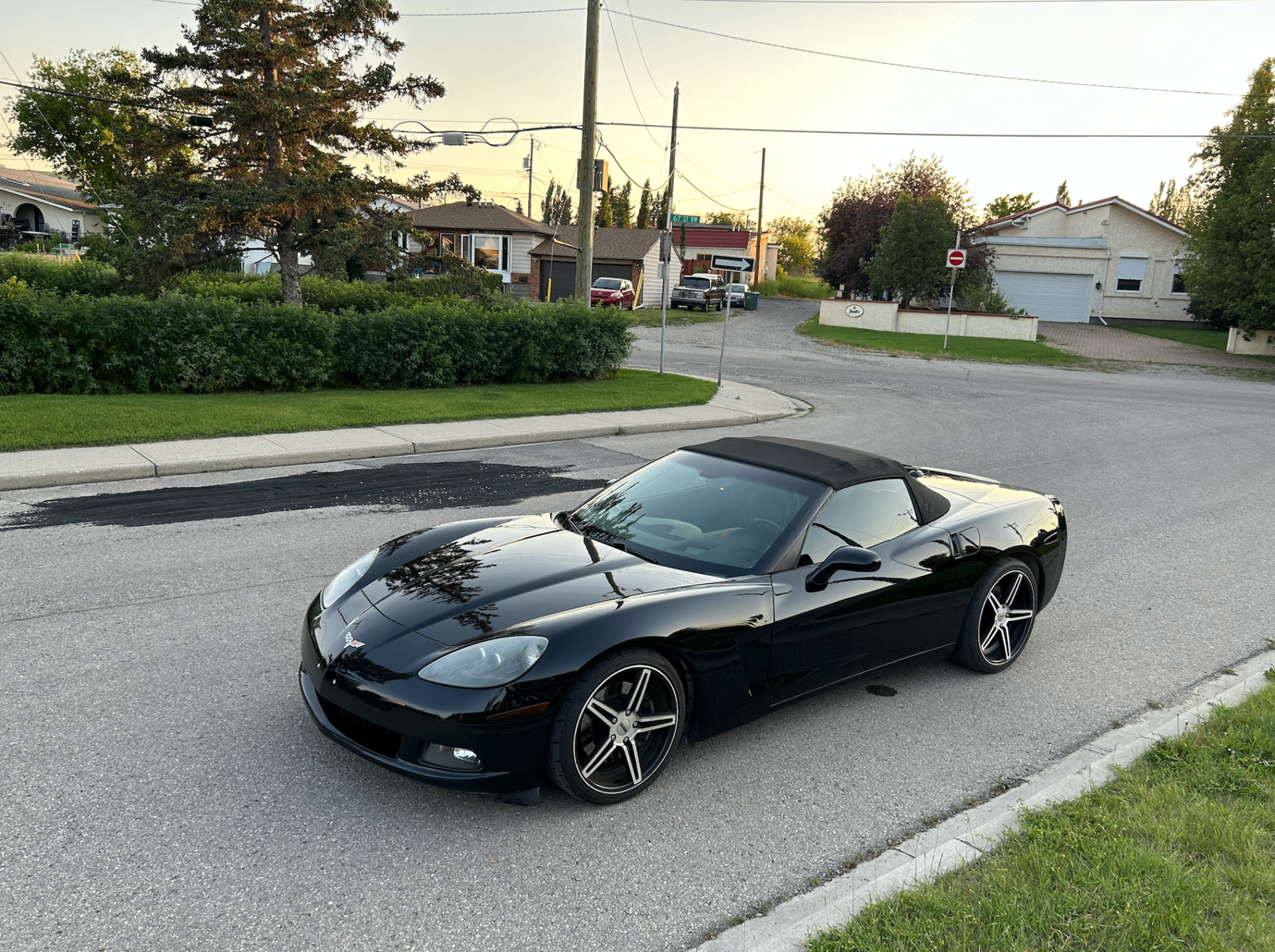 Black Chevrolet Corvette convertible at sunset