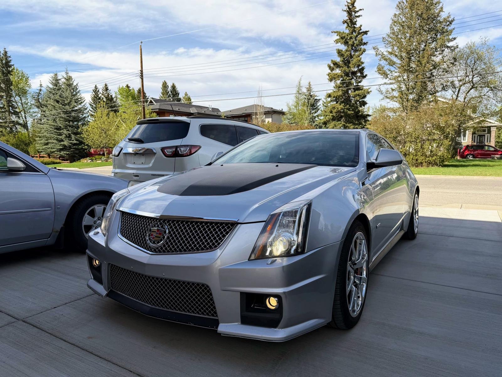 Silver Cadillac CTS-V coupe on a residential driveway