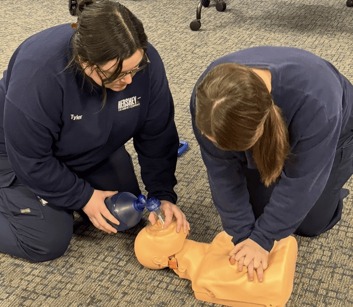 Two students practicing two-rescuer CPR with a bag-valve-mask in a West Covina class