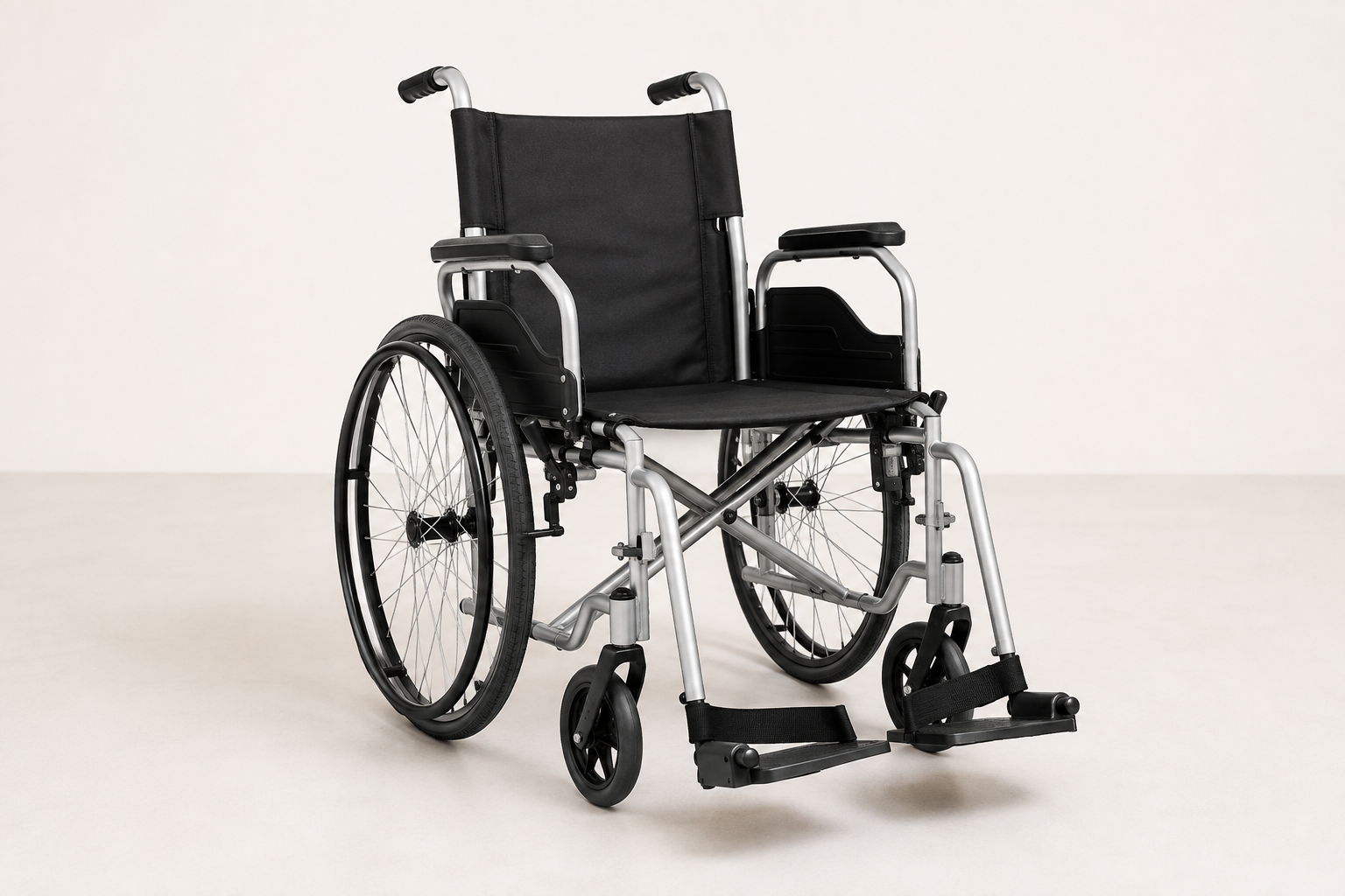 Empty compact manual wheelchair with a narrow seat and large rear wheels