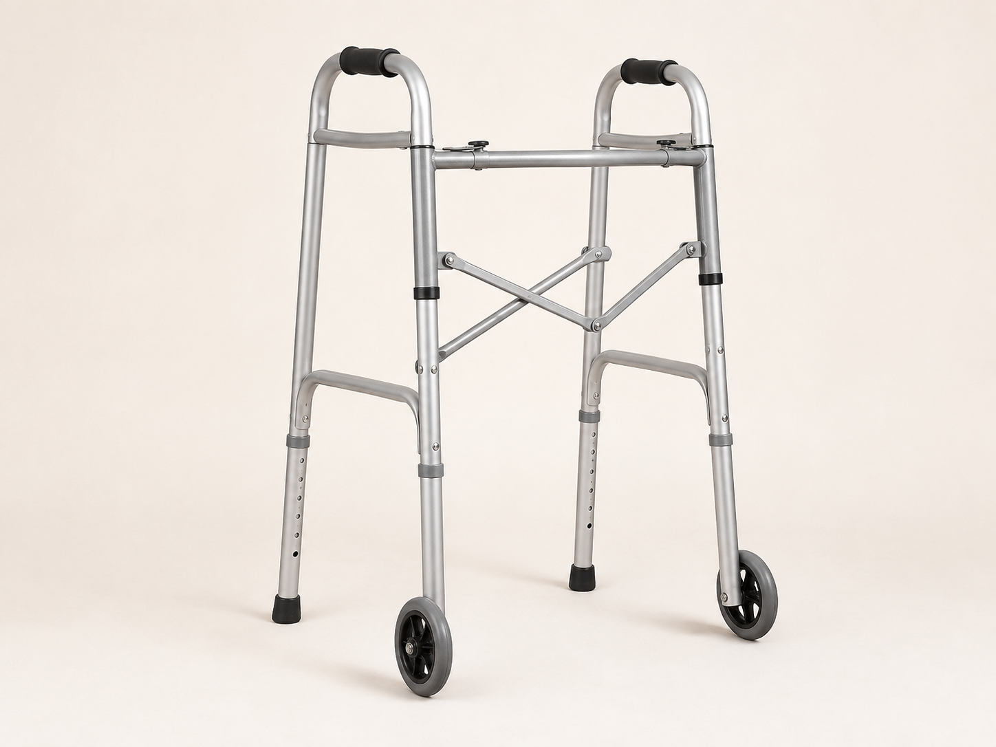Empty silver folding two-wheel walker with two front wheels and two rear rubber tips