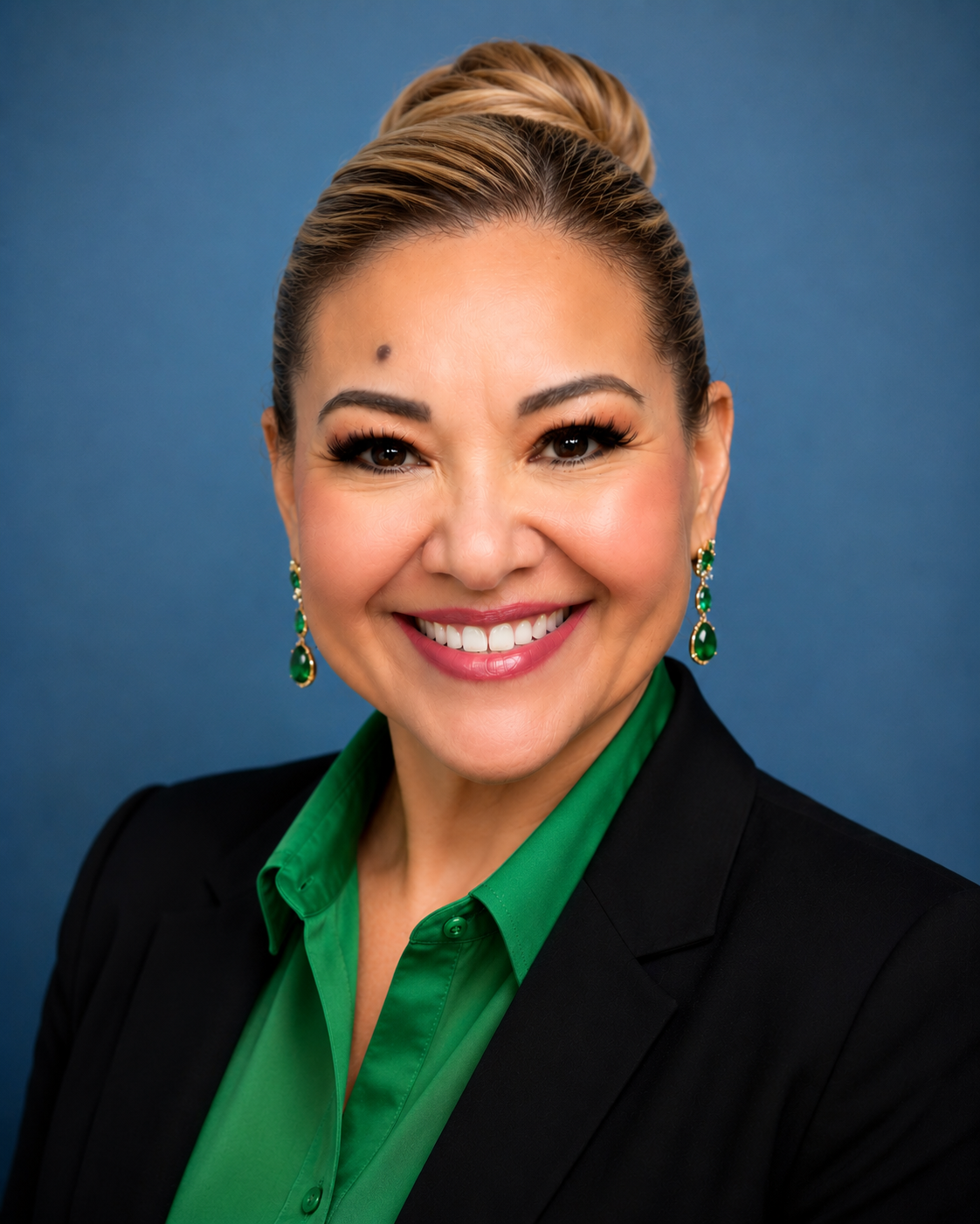 Natieli G. Pazdra, CHW/CHWI, healthcare consultant, smiling in a black blazer and emerald green blouse