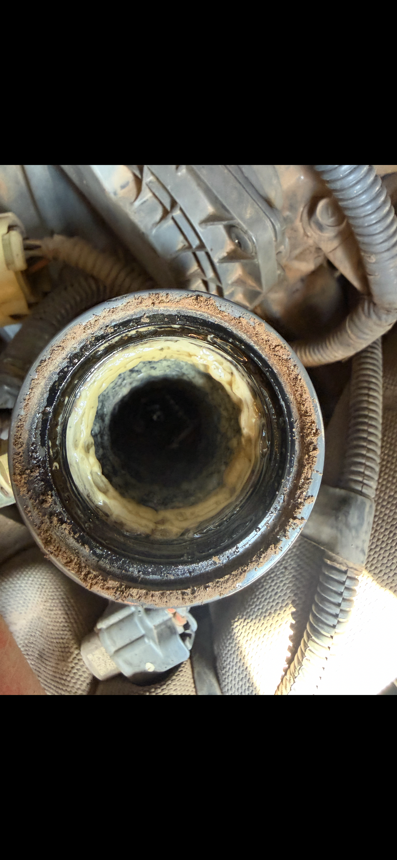 Oil filler neck packed with mayonnaise-like gunk from oil and coolant mixing on a skid steer diesel
