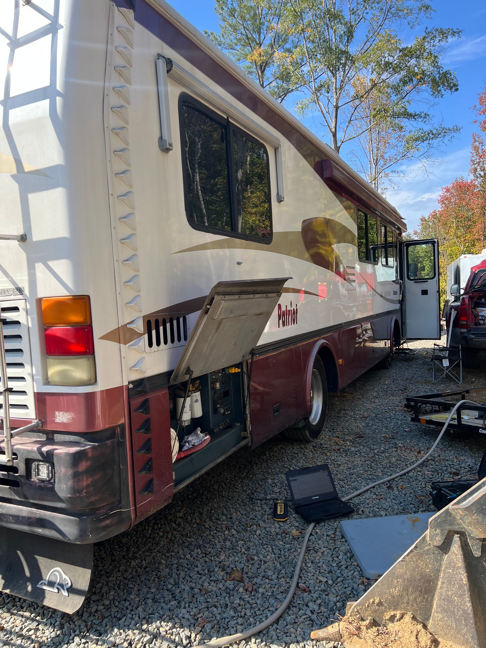 Service bay open on a Beaver Patriot motorhome with a diagnostic laptop connected during CAT 3126B testing